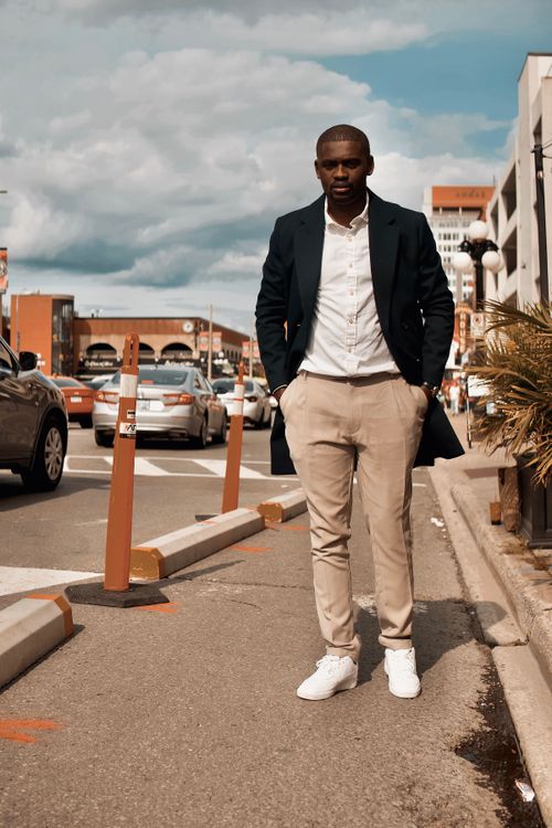 Free Well-dressed African American man posing confidently in Ottawa city street. Stock Photo