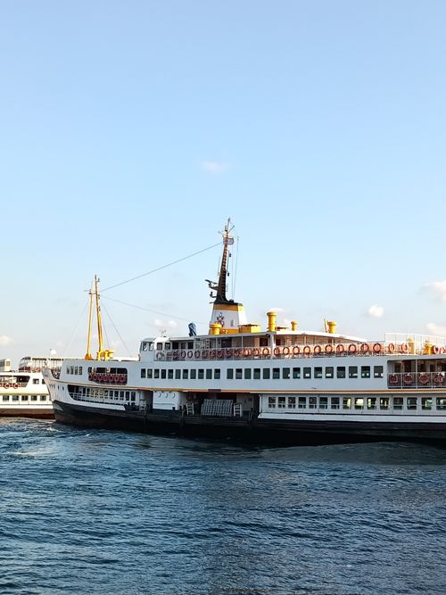 Free A large white ferry sailing across a calm blue sea under a clear sky. Stock Photo