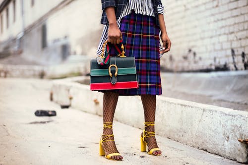 Woman Holding Green and Red Leather Handbag