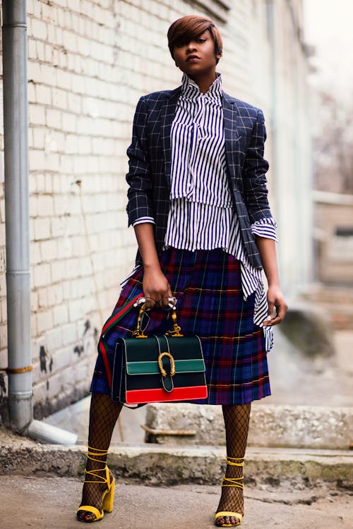 Free Woman in Blue and White Plaid Cardigan Holding Green and Red Handbag Stock Photo