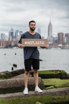 Man in Black Crew Neck T-shirt Holding the Beach Signage