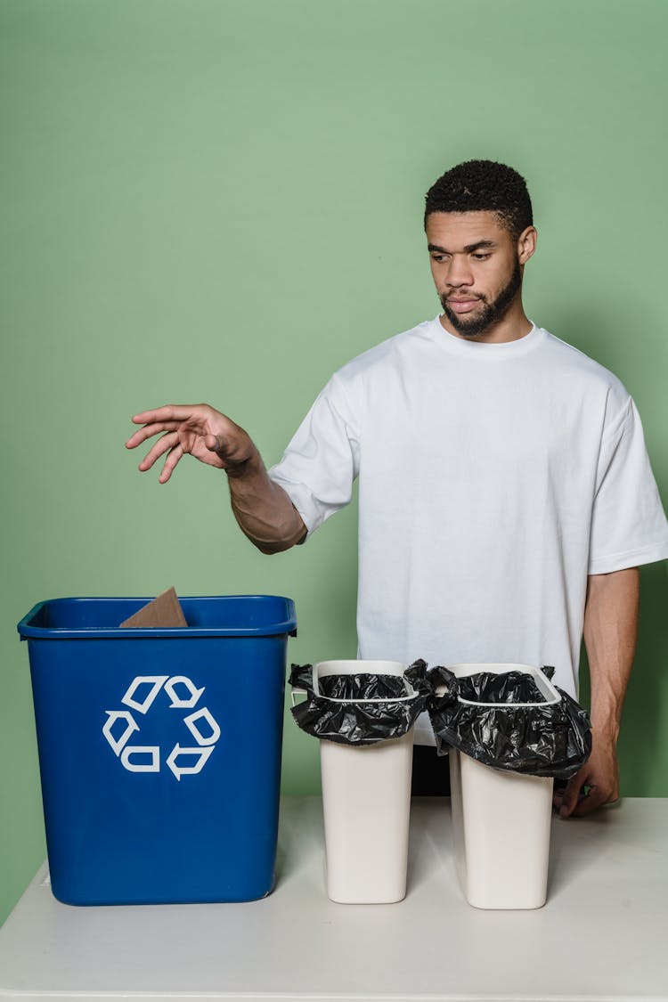 A Man Throwing A Trash