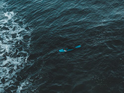 A Person Surfing on Sea Waves