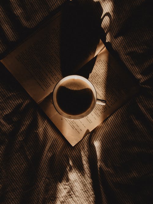 A Cup of Coffee on an Open Book
