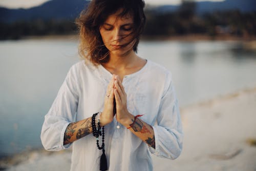 A Woman Praying on the Beach