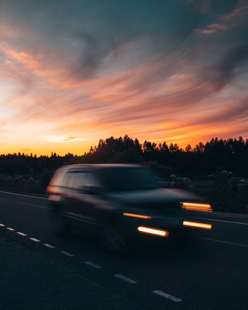 Free Fast Moving Car on the Road During Evening Stock Photo