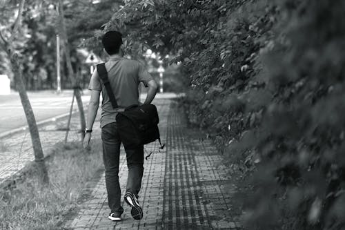 Man Wearing T-shirt; Pants; Crossbody Bag