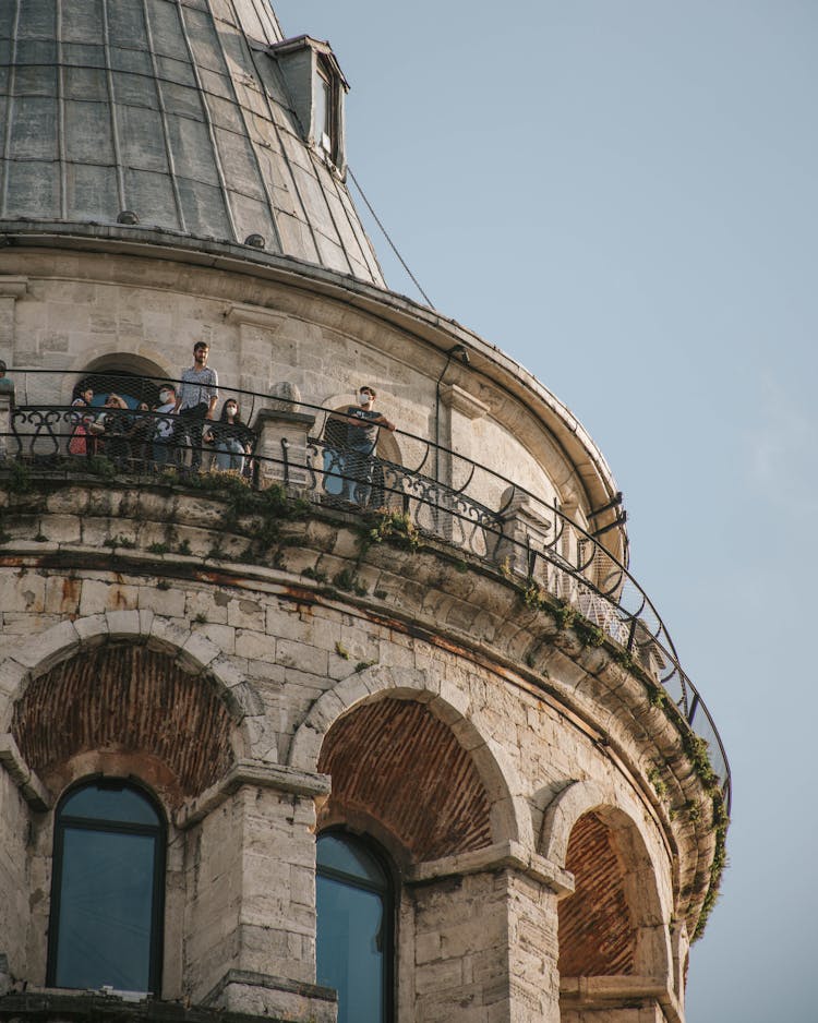 Old Stone Building With Balcony Against Blue Sky