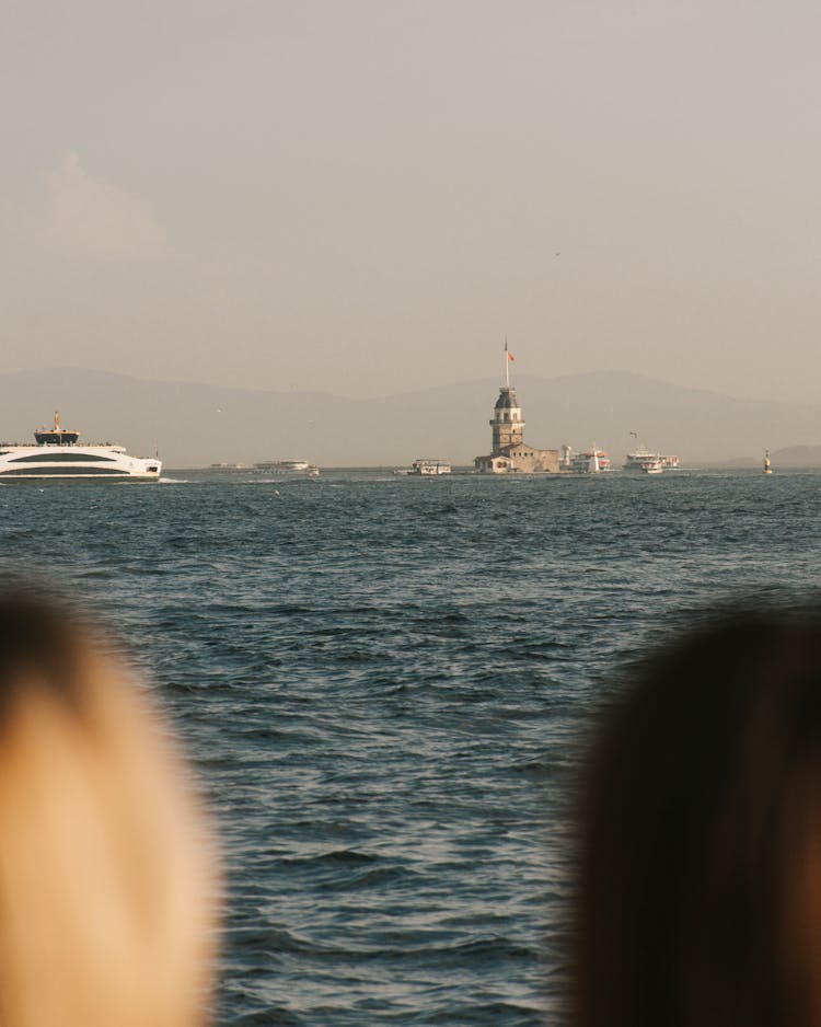 Women Watching Ship In Water