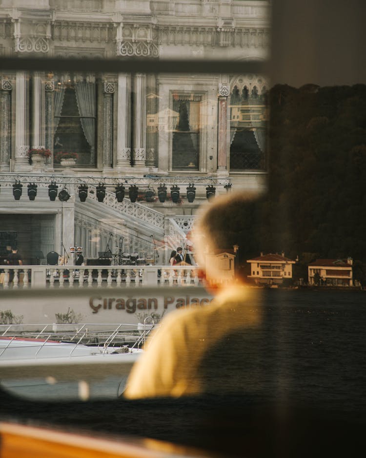 Closeup Of A Man Looking At Heritage Architecture From A Ferry And Reflections In Glass