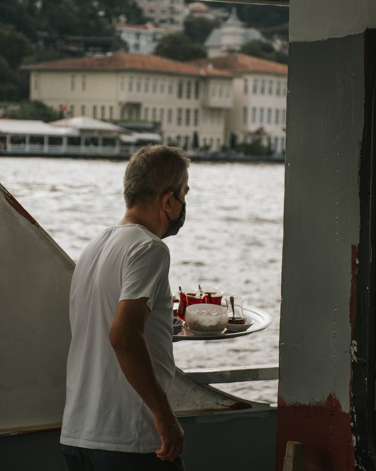 Waiter With Food On Tray Near River