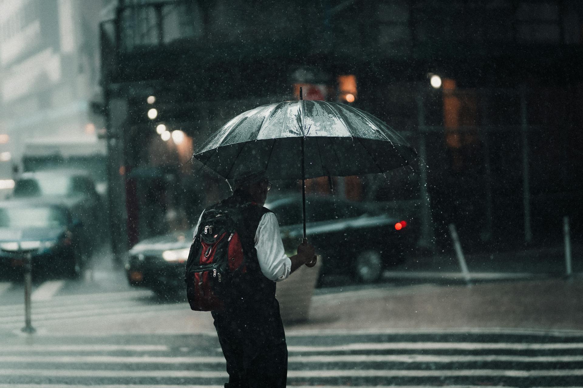 A Man with an Umbrella in a City