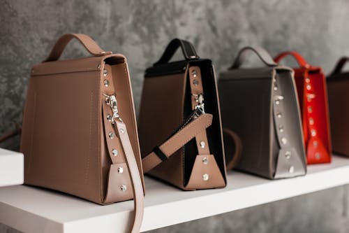 Leather Bags on White Wooden Shelf