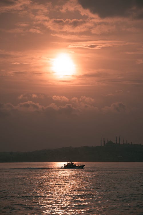 Silhouette of Boat on Sea During Sunset