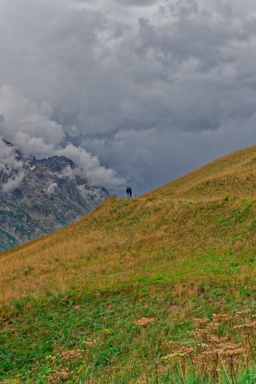 People Hiking in Mountains