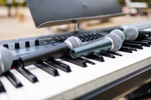 Close-up of microphones on an electronic keyboard, perfect for band practice or live performances.