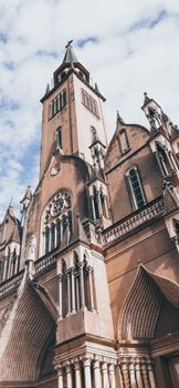 Low angle shot of a Gothic cathedral facade in Río Cuarto, showcasing intricate architecture.