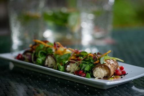 Free Close-up of a gourmet vegetarian dish with fresh vegetables on an elegant plate, showcasing vibrant colors and textures. Stock Photo