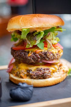 Scrumptious double cheeseburger with fresh toppings on a rustic serving board.