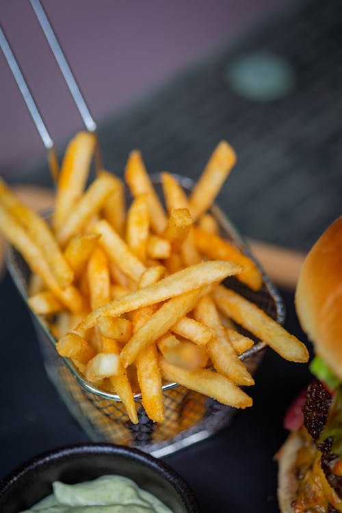 Free French Fries on Basket Strainer Stock Photo