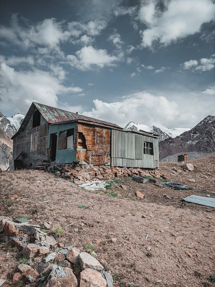 Damaged Building Of Arctic Base In Snowcapped Mountains