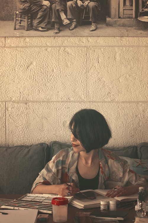 Woman Sitting at Table Painting