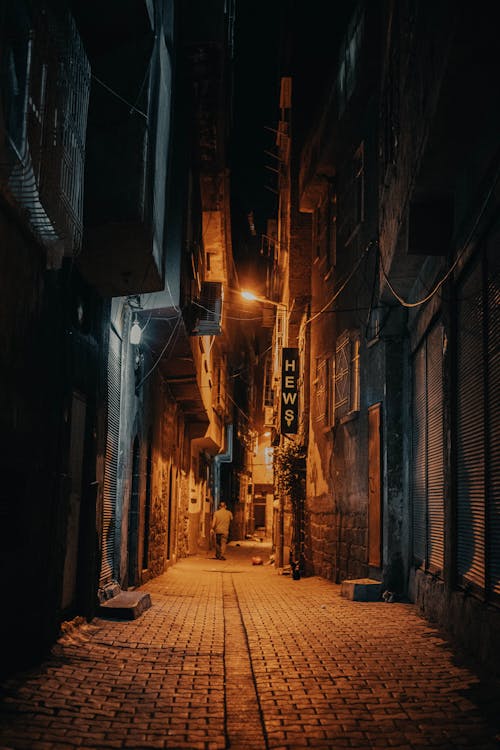 Man Walking on Alley at Night