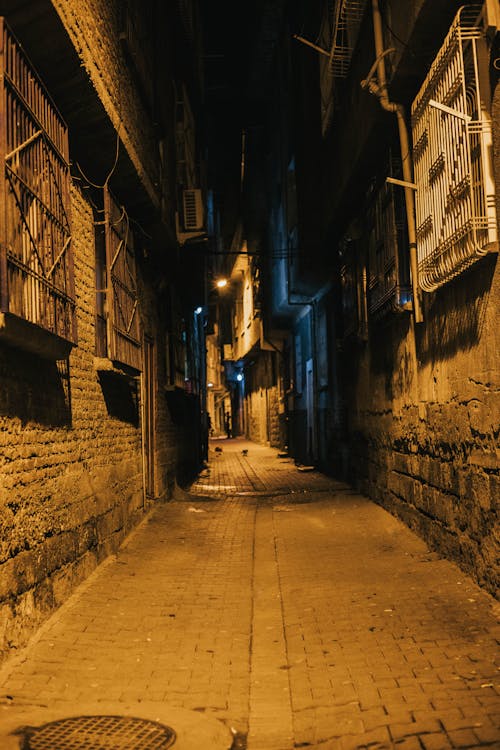 Free Empty Alley in Between Buildings at Night Stock Photo