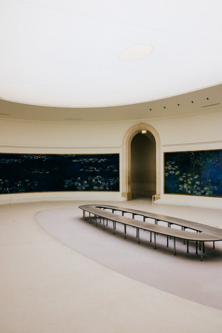 Round Gallery Space With Glass Ceiling And Modernist Furniture