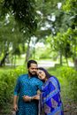Woman in Blue and Pink Long Sleeve Shirt Hugging Man in Blue and White Long Sleeve