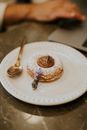 A Donut with Chocolate Filling on a Ceramic Plate