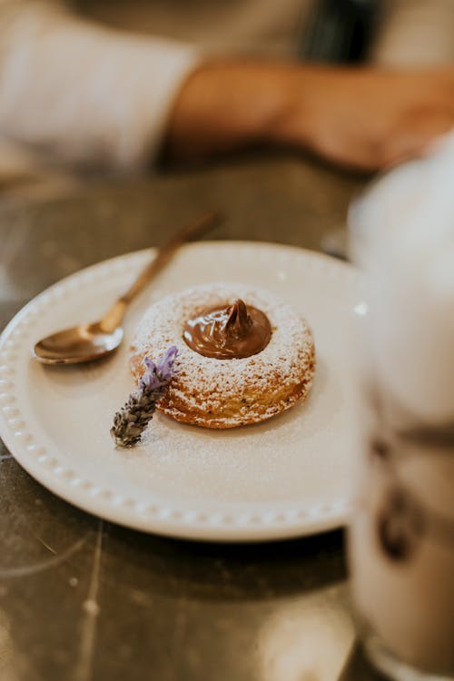 Brown and White Round Pastry on White Ceramic Plate