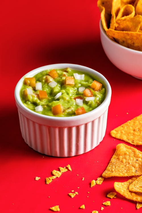 Free A Bowl of Green Dip with Diced Tomatoes Stock Photo