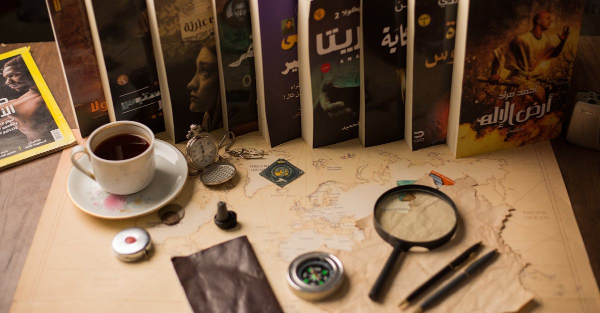 Warm desk scene featuring books, a map, and vintage items like a compass and magnifying glass.