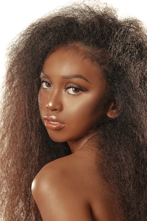 Portrait of a Beautiful Woman with Curly Hair Looking at the Camera