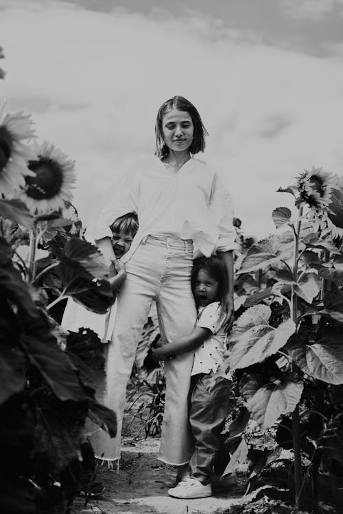 A Woman Standing on the Field with Her Kids