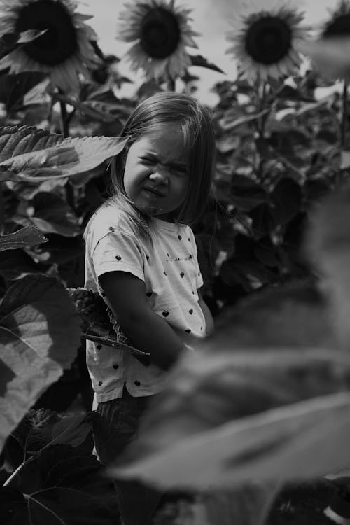 A Girl Standing Near Sunflowers