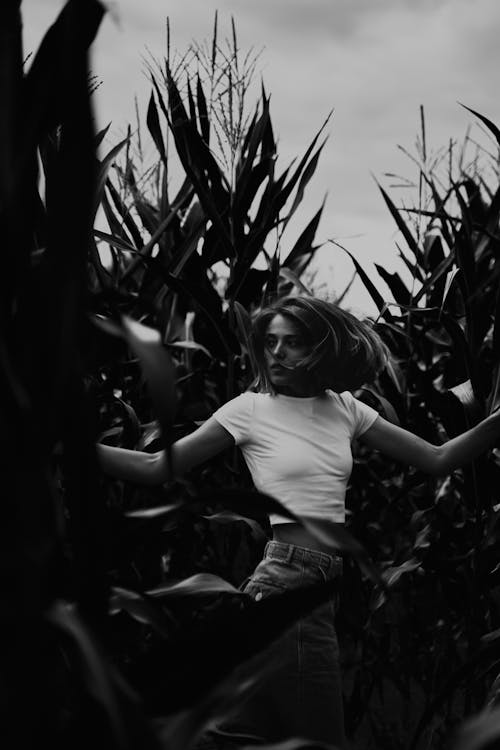 Grayscale Photo of a Woman in the Corn Field