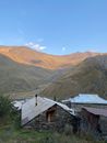 White and Brown Houses Near Brown Mountains Under Blue Sky