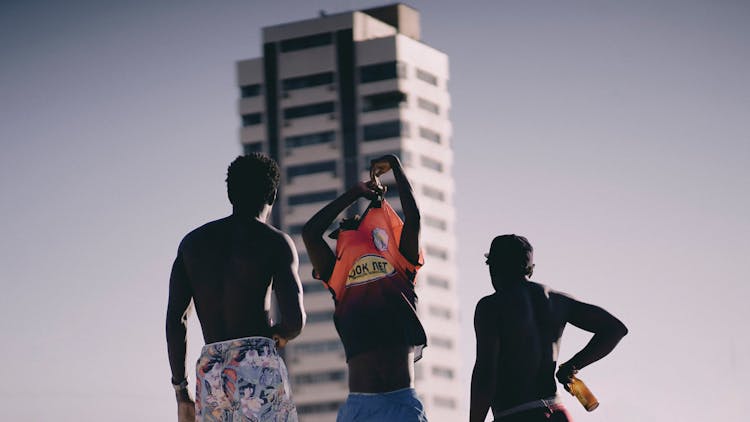 Boys In Sportswear On Skyscraper Background