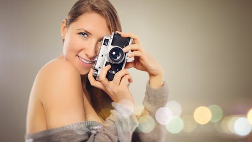 Free Woman With Gray Dress Holding Camera Stock Photo