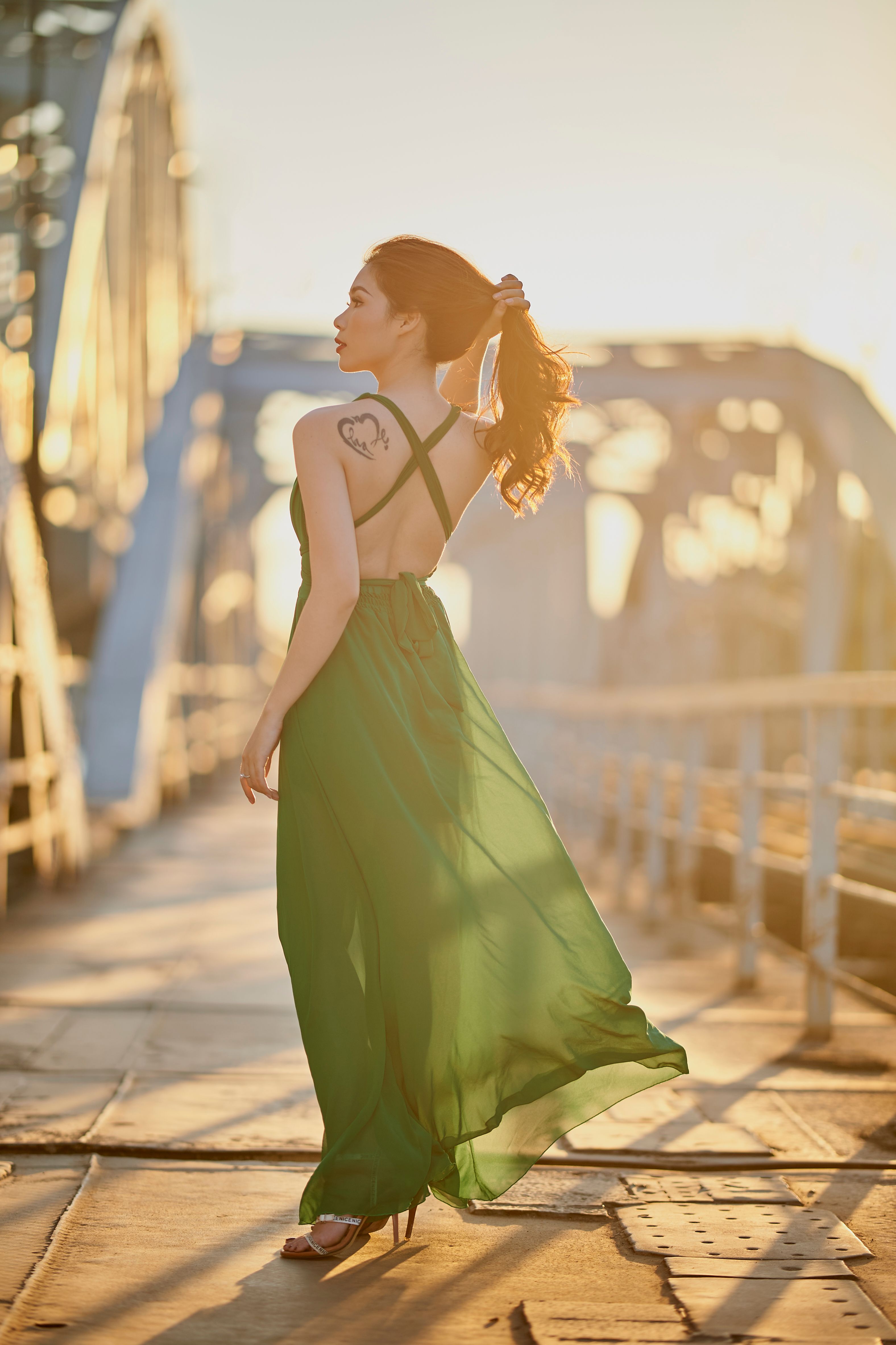 Elegant Woman in Red Dress Strolling Outdoors · Free Stock Photo