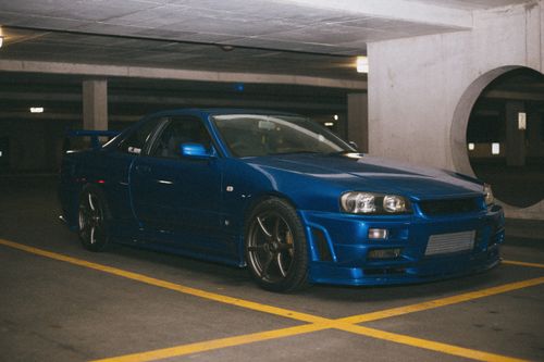 Free Striking blue Nissan Skyline GT-R parked in an urban indoor garage. Stock Photo