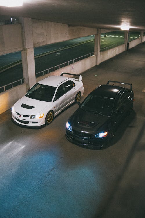 Free High-Angle Shot of Two Mitsubishi Lancer Evolution Parked Next to Each Other Stock Photo