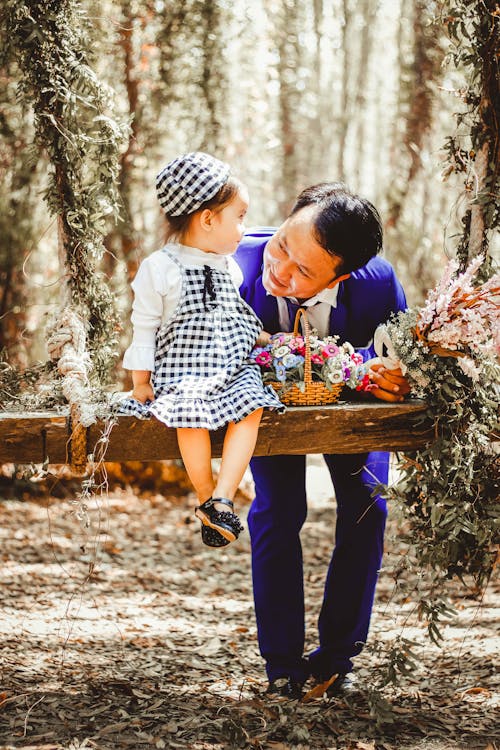 A Man and his Little Daughter Posing in a Forest