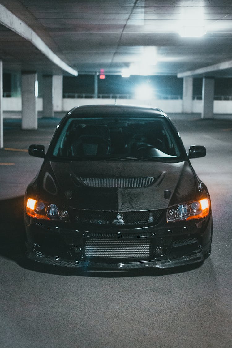 A Black Mitsubishi Lancer Evolution In A Parking Lot