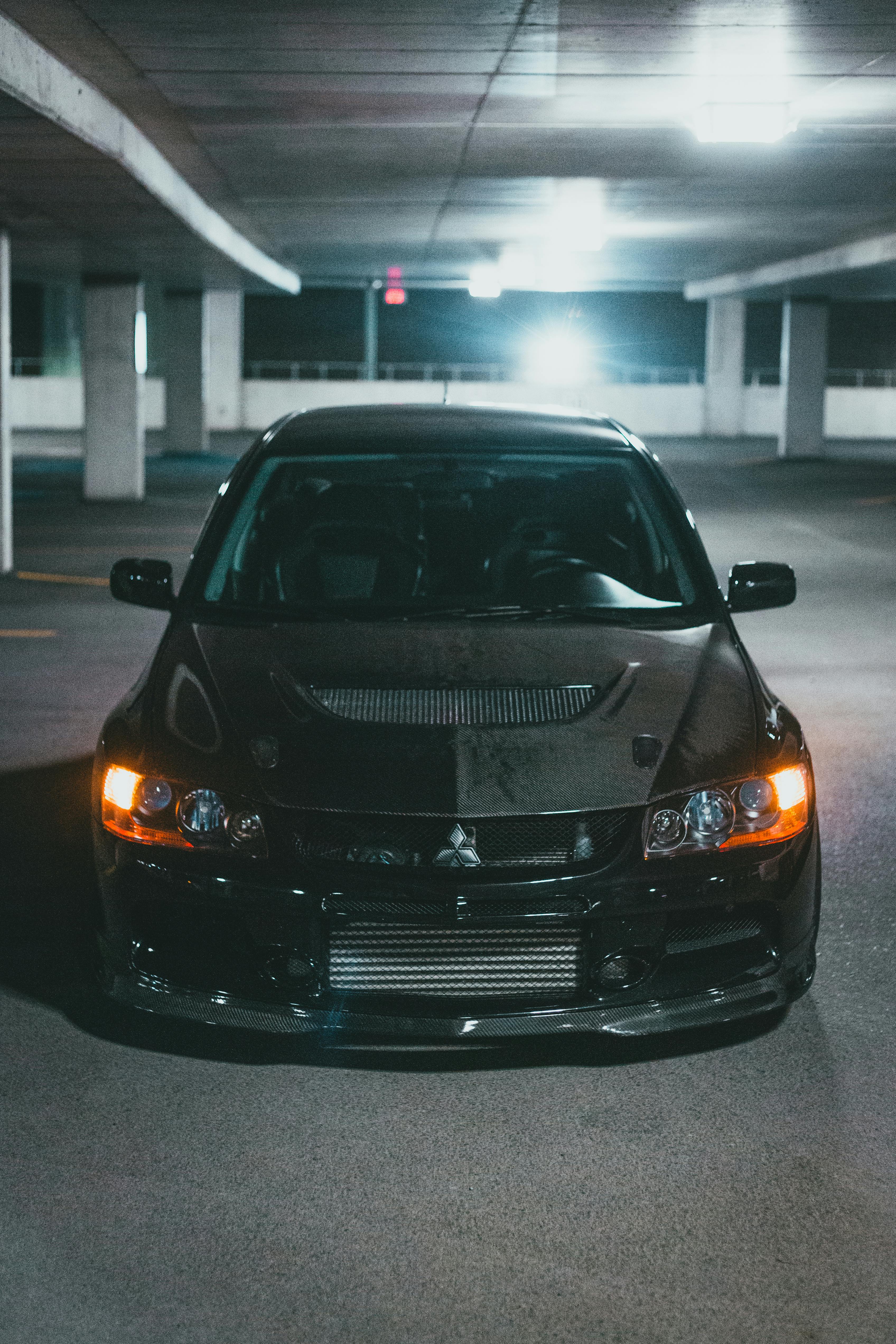 A Black Mitsubishi Lancer Evolution in a Parking Lot · Free Stock Photo