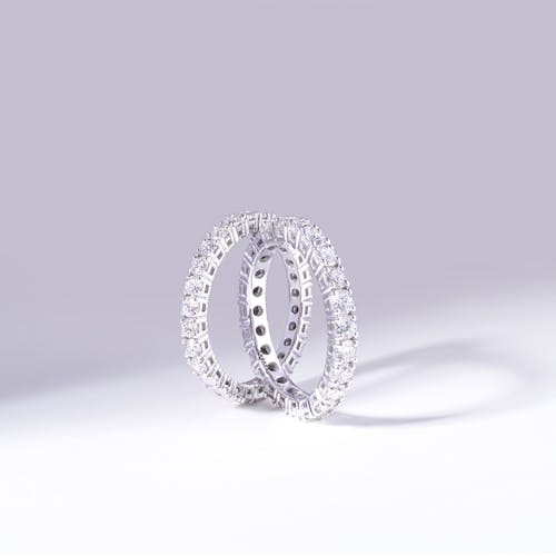 Free Silver Diamond Studded Rings on White Surface Stock Photo