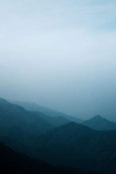 Captivating view of a misty mountain range at dawn, evoking tranquility.