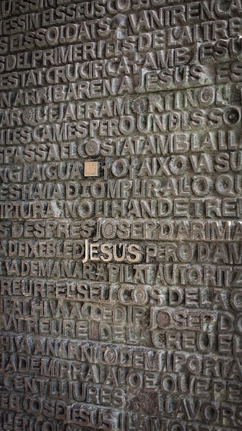 Free A Gray Concrete Wall with Biblical Inscriptions Stock Photo